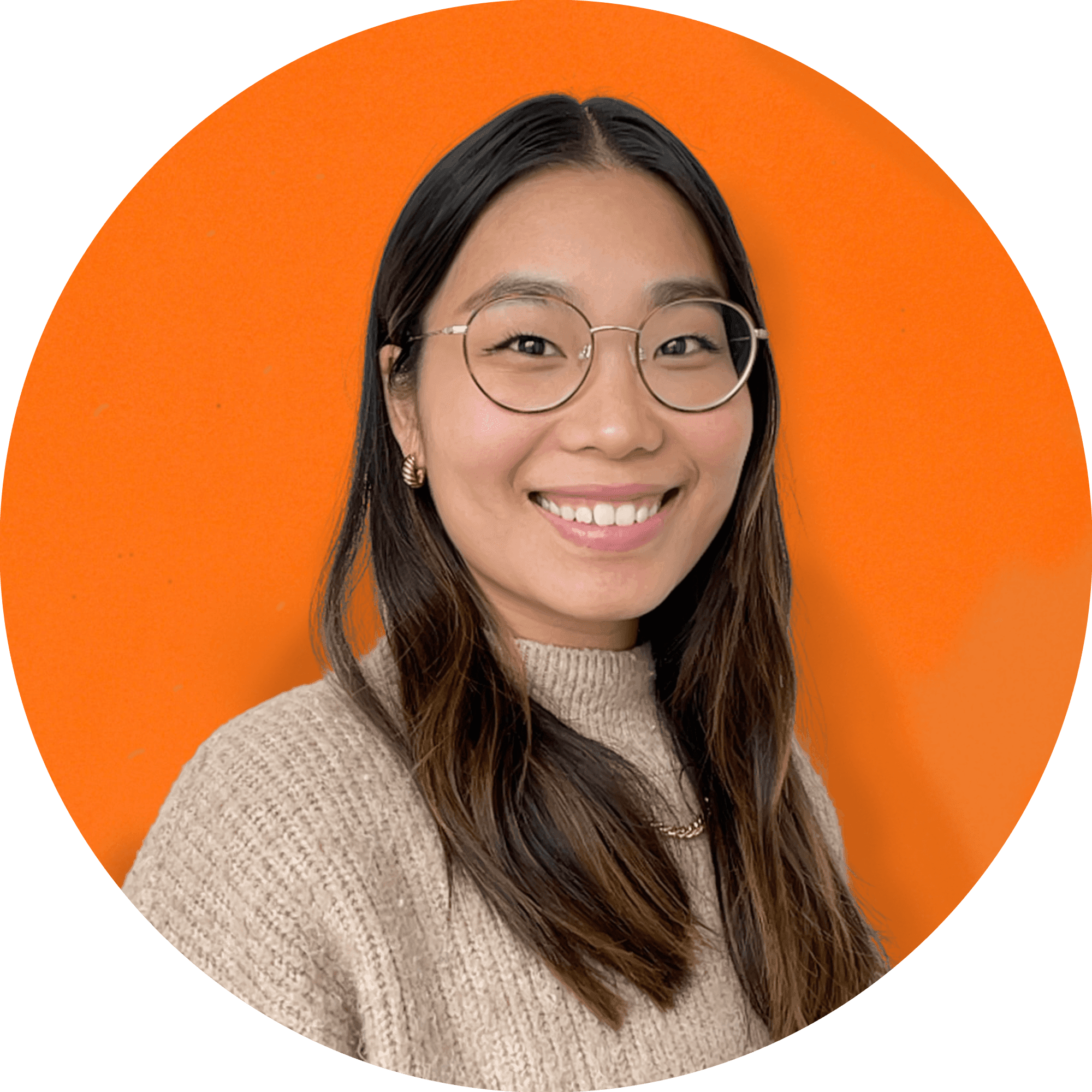 Smiling person with glasses, orange background.