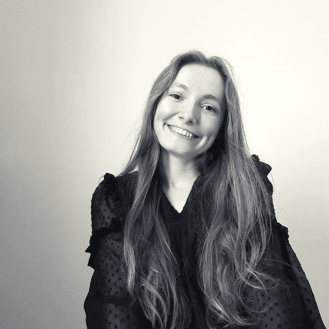 Smiling woman with long hair, black blouse.