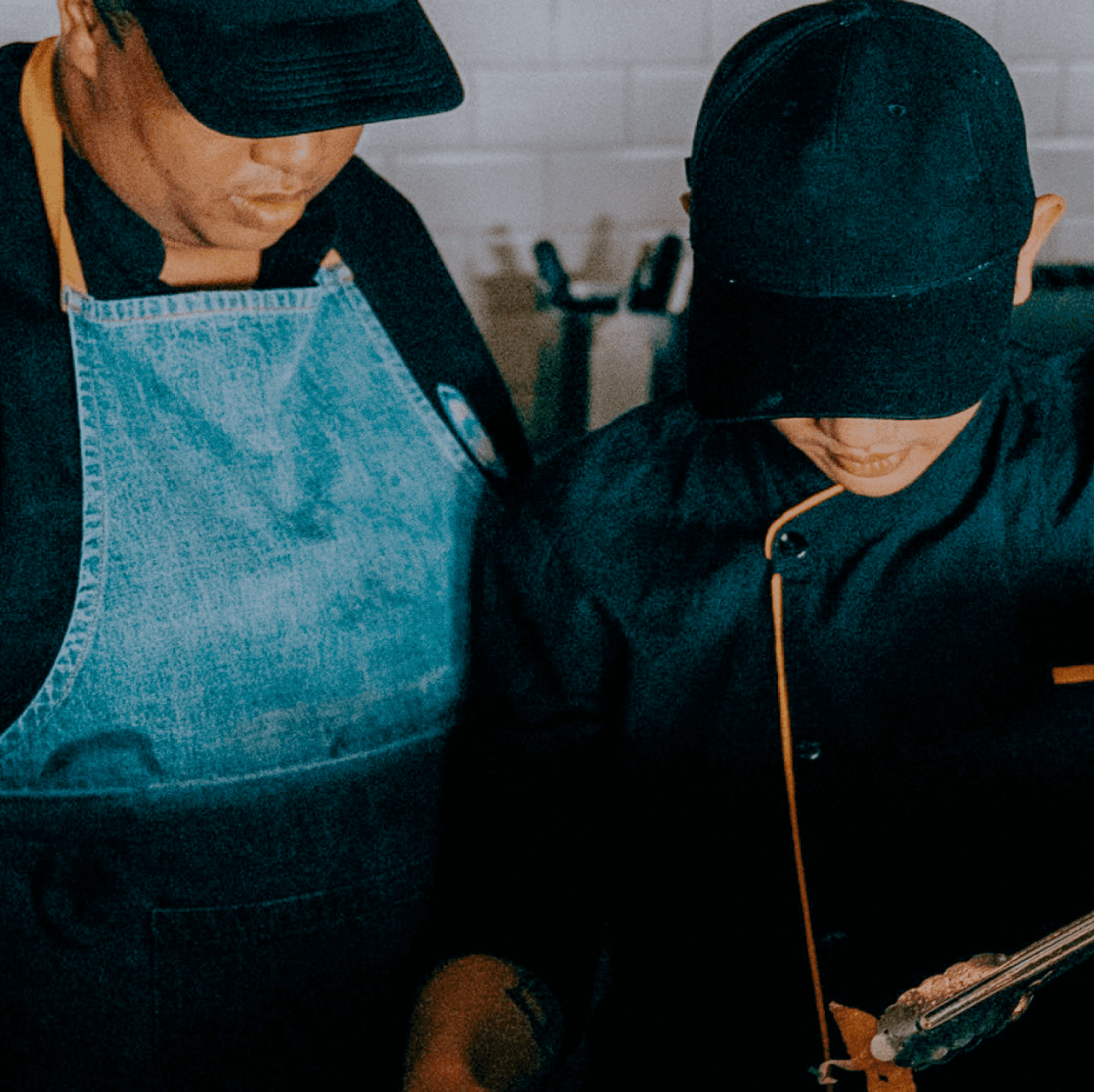 Two restaurant employees looking down