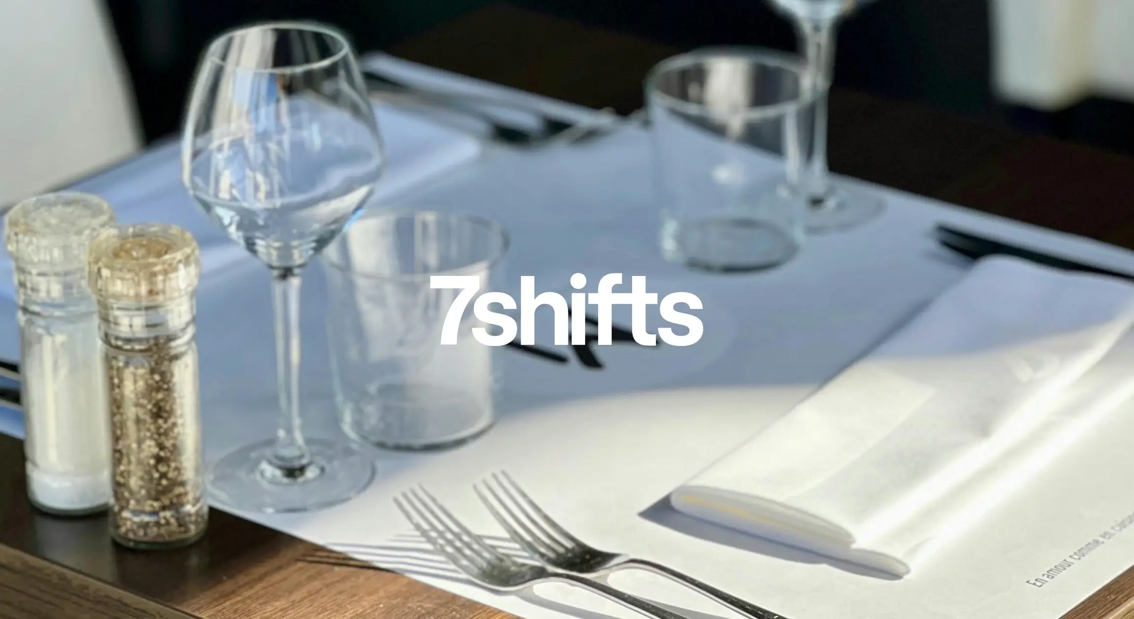 Restaurant table setting with glassware and napkins.