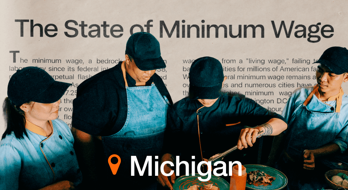 Workers discussing minimum wage in Michigan restaurant.