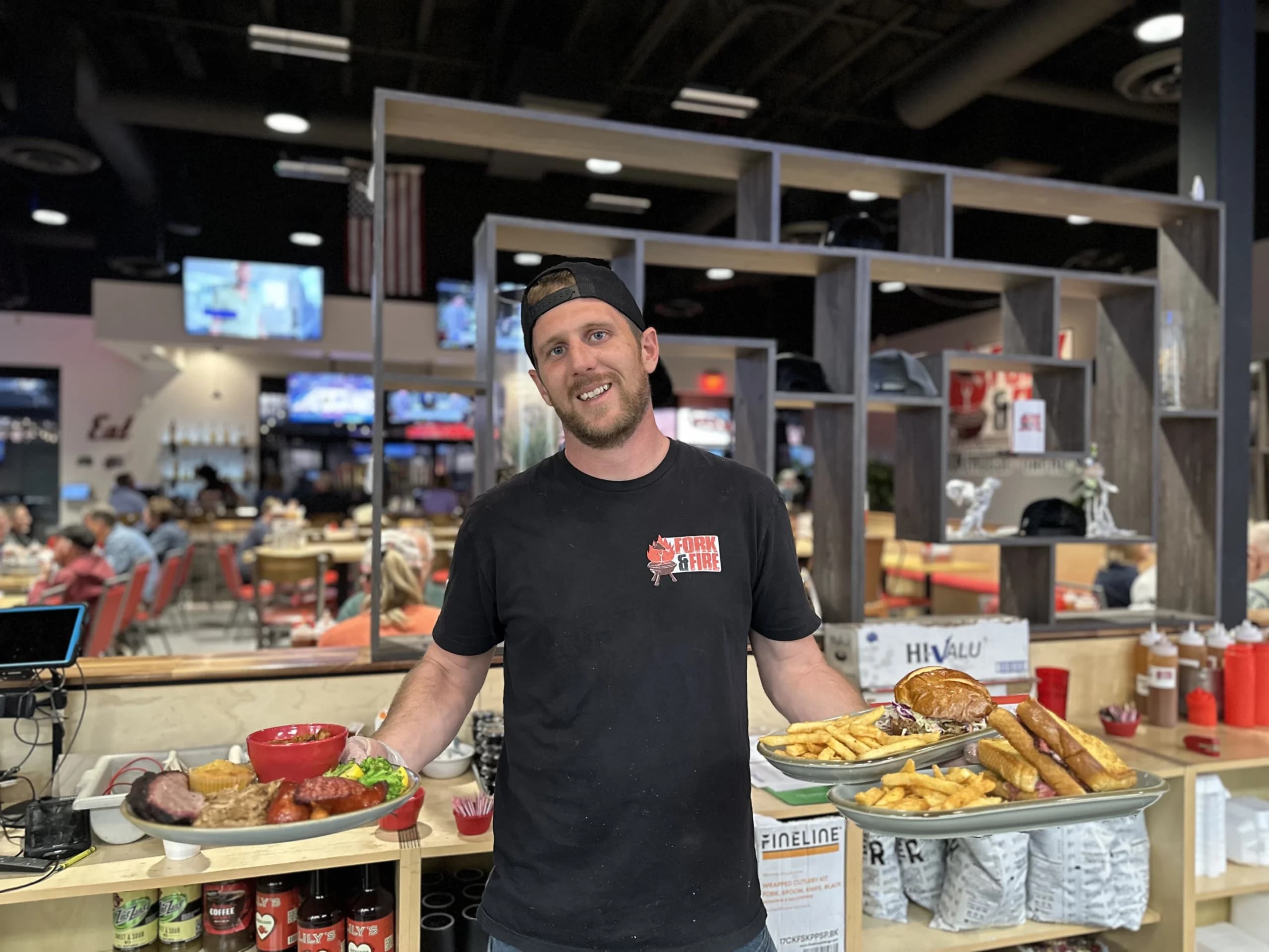 Server holding plates of food in a restaurant
