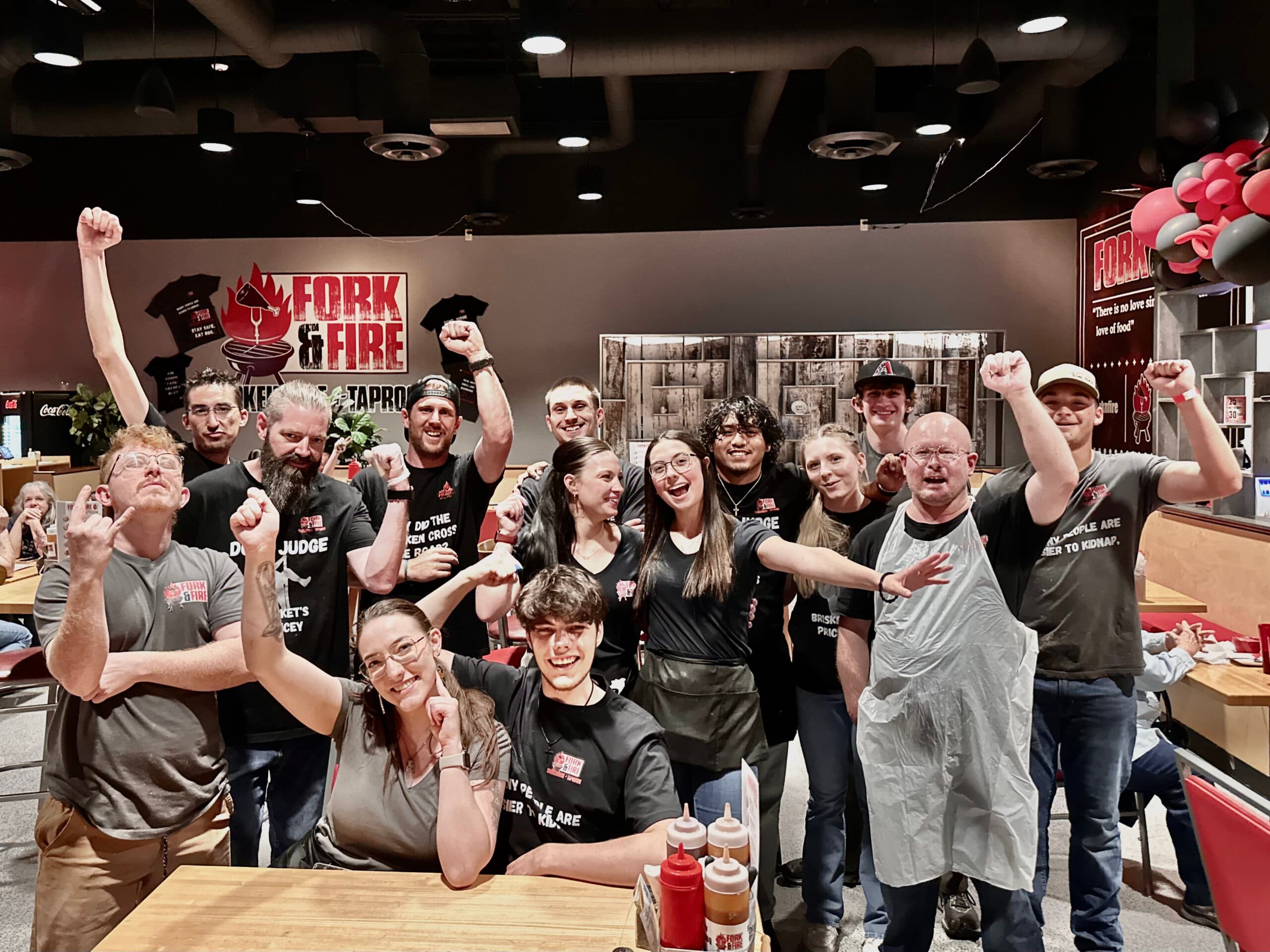 Team at Fork & Fire restaurant celebrating together.