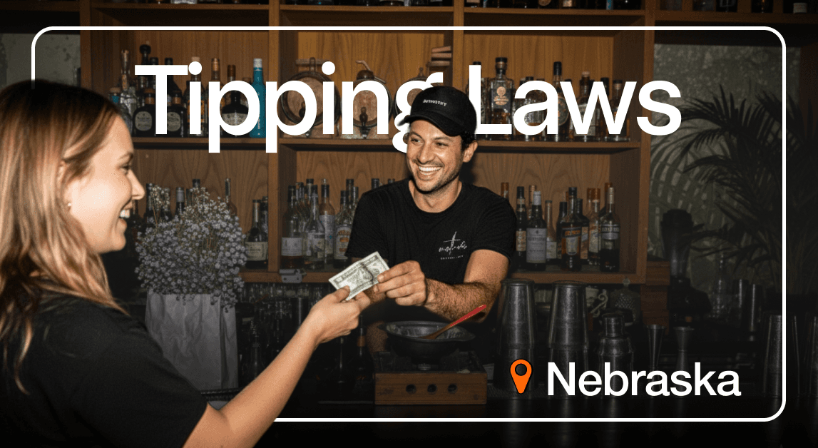 Smiling bartender receives tip in Nebraska bar.