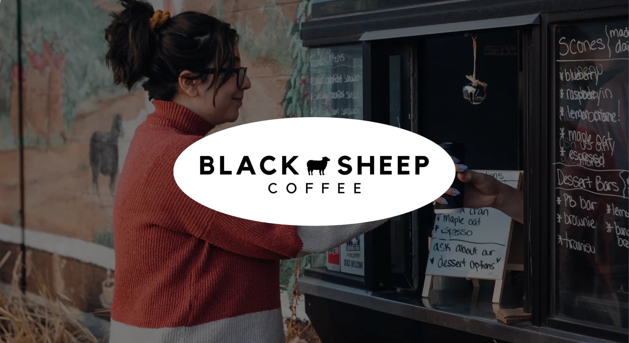 Guest at Black Sheep Coffee grabbing coffee from window