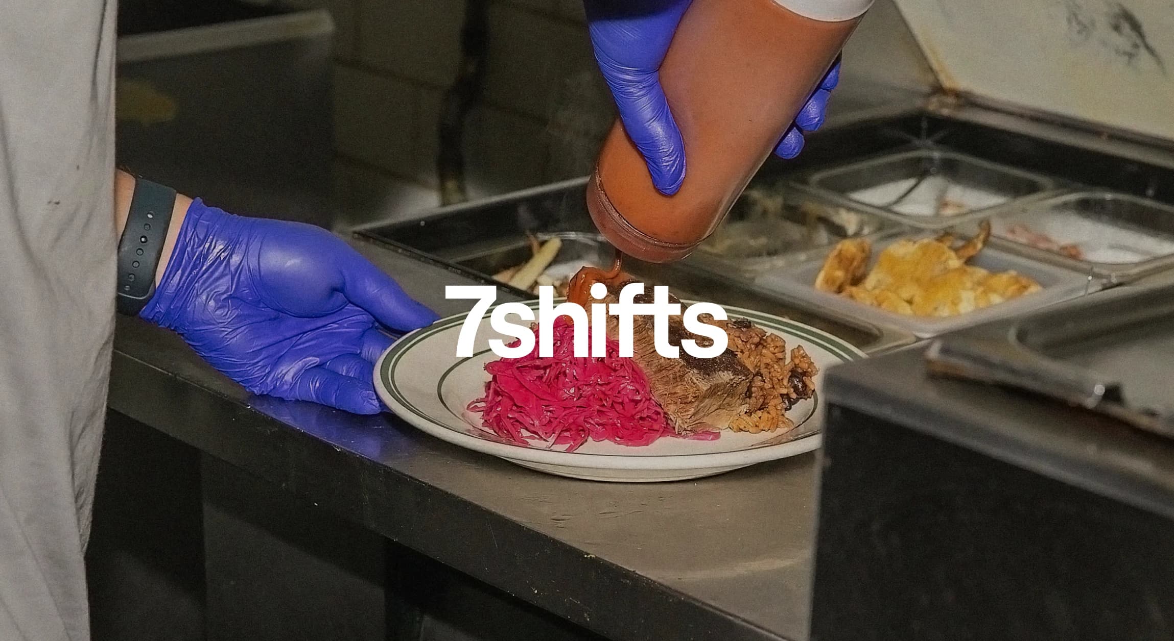 Chef preparing plate with sauce and gloves