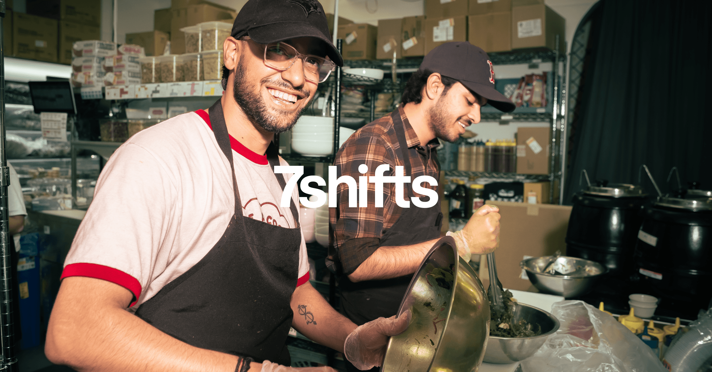 Two happy employees cooking in the restaurant kitchen