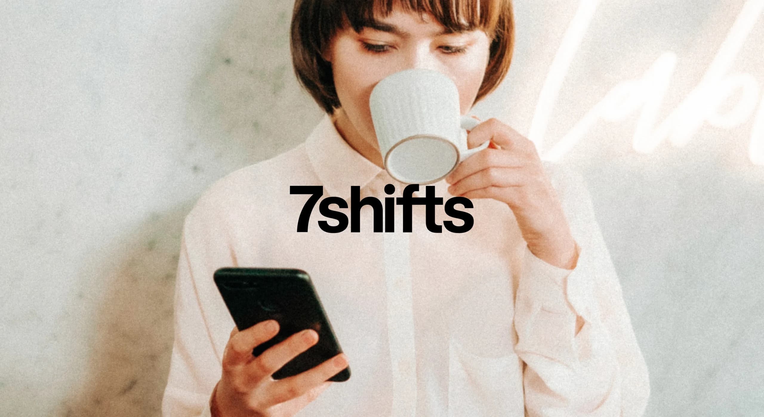 Person using a phone, drinking coffee, 7shifts logo.