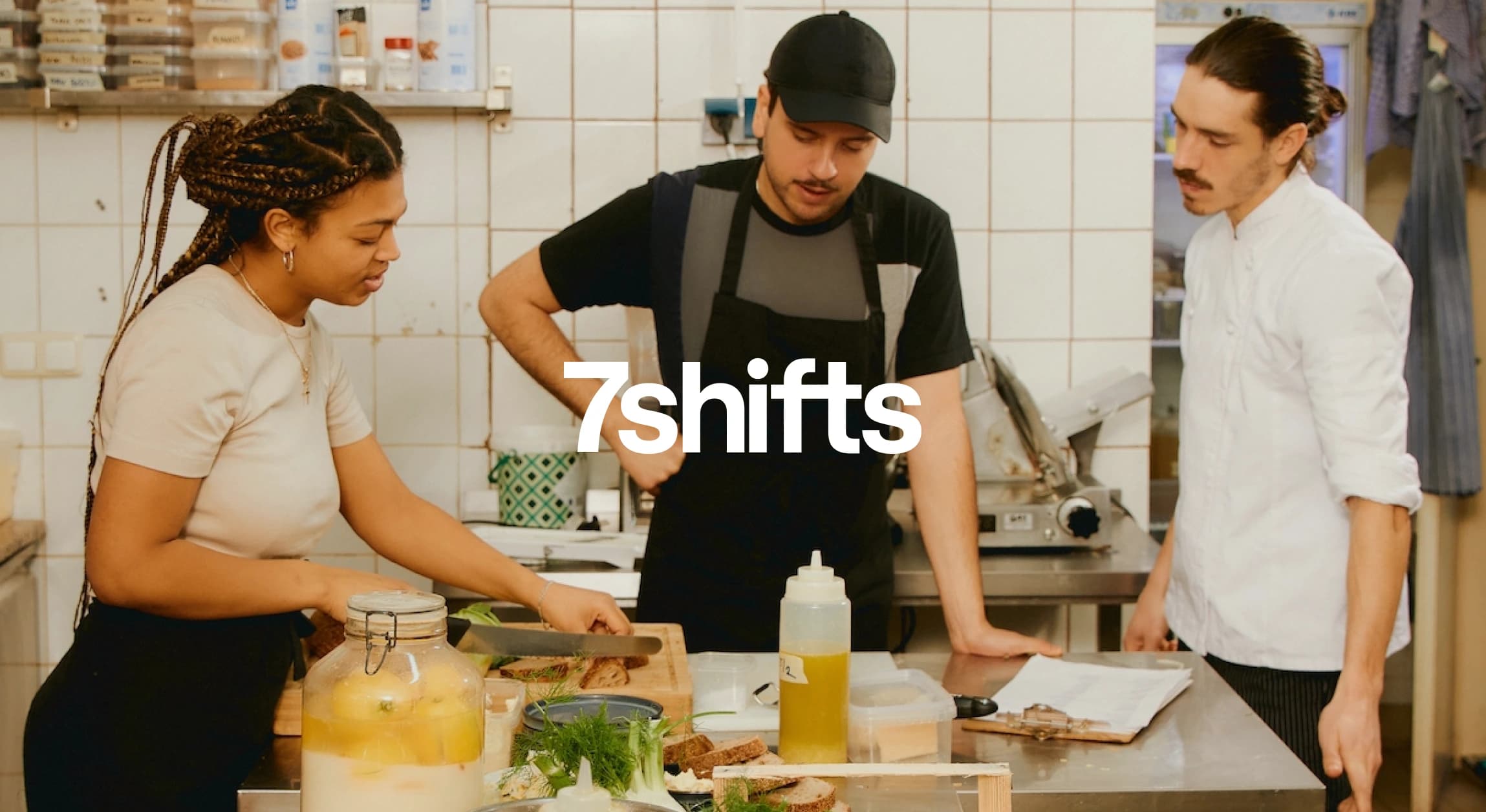 Three chefs preparing food in restaurant kitchen