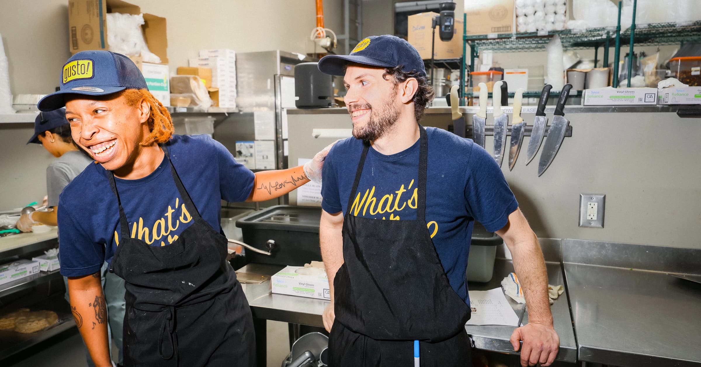 Two chefs laughing in kitchen