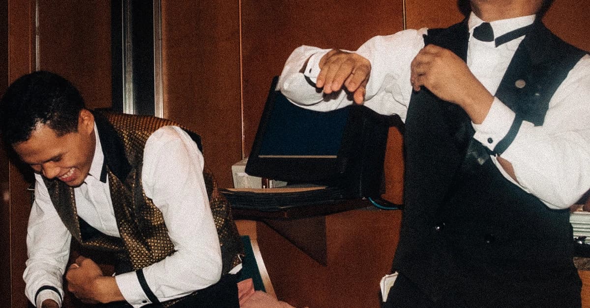 Two fine dining servers standing in restaurant