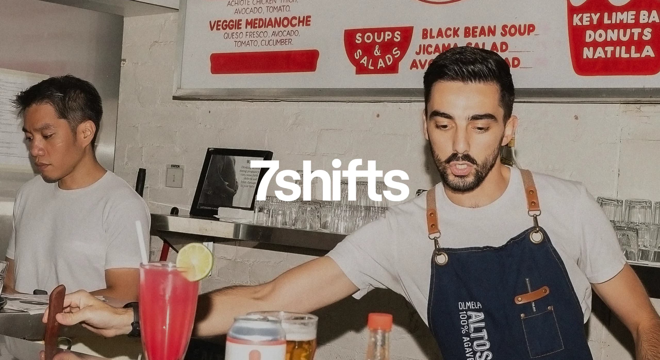 Bartender serving drinks at a busy restaurant