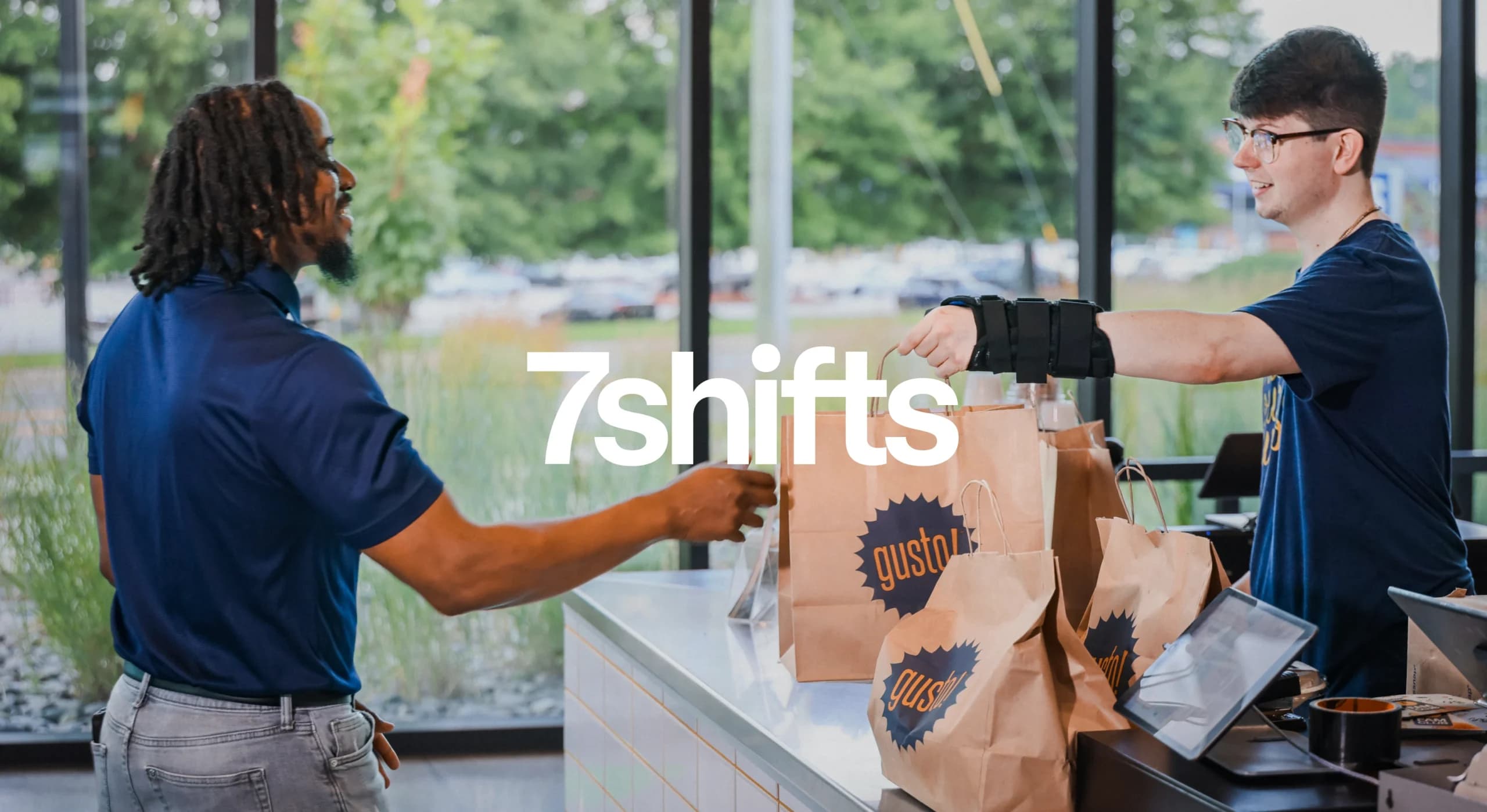 Person receiving food bags at counter
