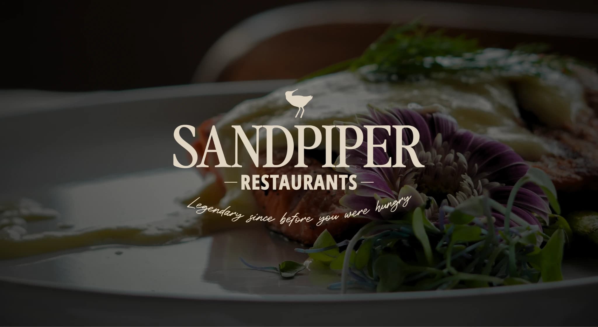 The Sandpiper logo with salmon dish in background