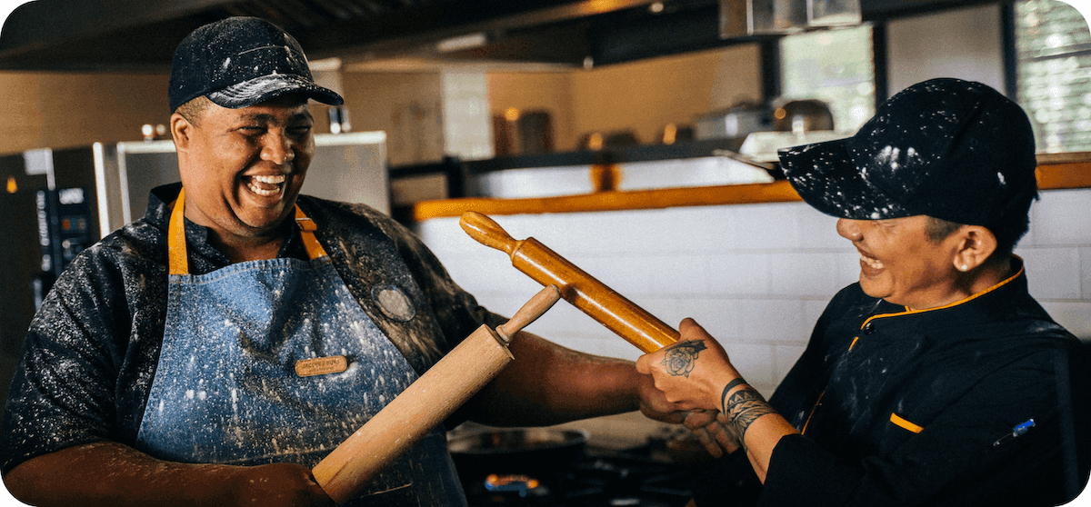 Serving What's Next Scholarship video thumbnail: showing two bakers with their rolling pins in the air.